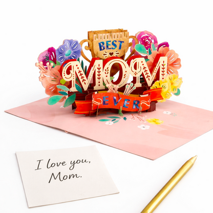 Colorful 3D pop-up card for Mother's Day with flowers and 'Best Mom Ever' text on a white background.