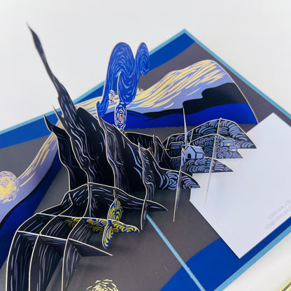 Pop-up card with a blue and black design featuring a landscape and abstract elements.