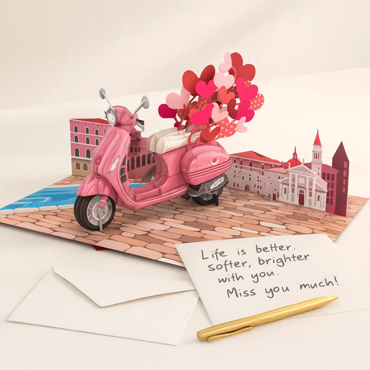 Pop-up card with pink scooter and heart balloons on a cityscape background
