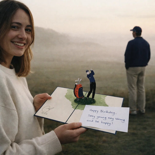 Woman holding a birthday card with a golfer on a golf course, with a man in the background.
