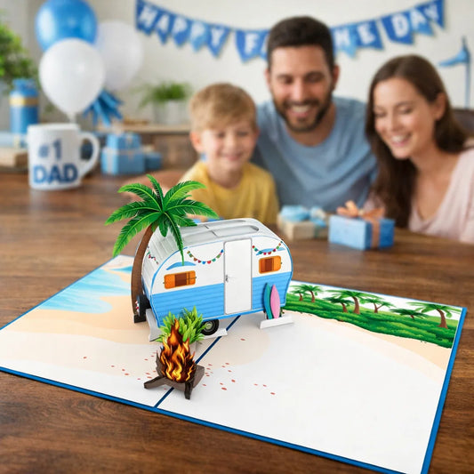 Family at a table with a pop-up card featuring a camper and palm tree