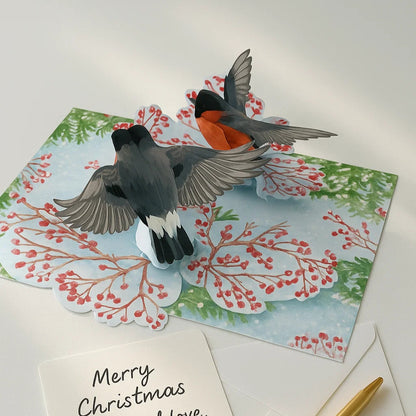 Christmas card with birds and a pen on a white surface
